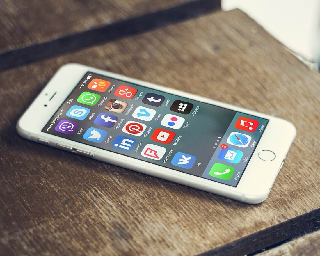 Social media apps on a smartphone screen.